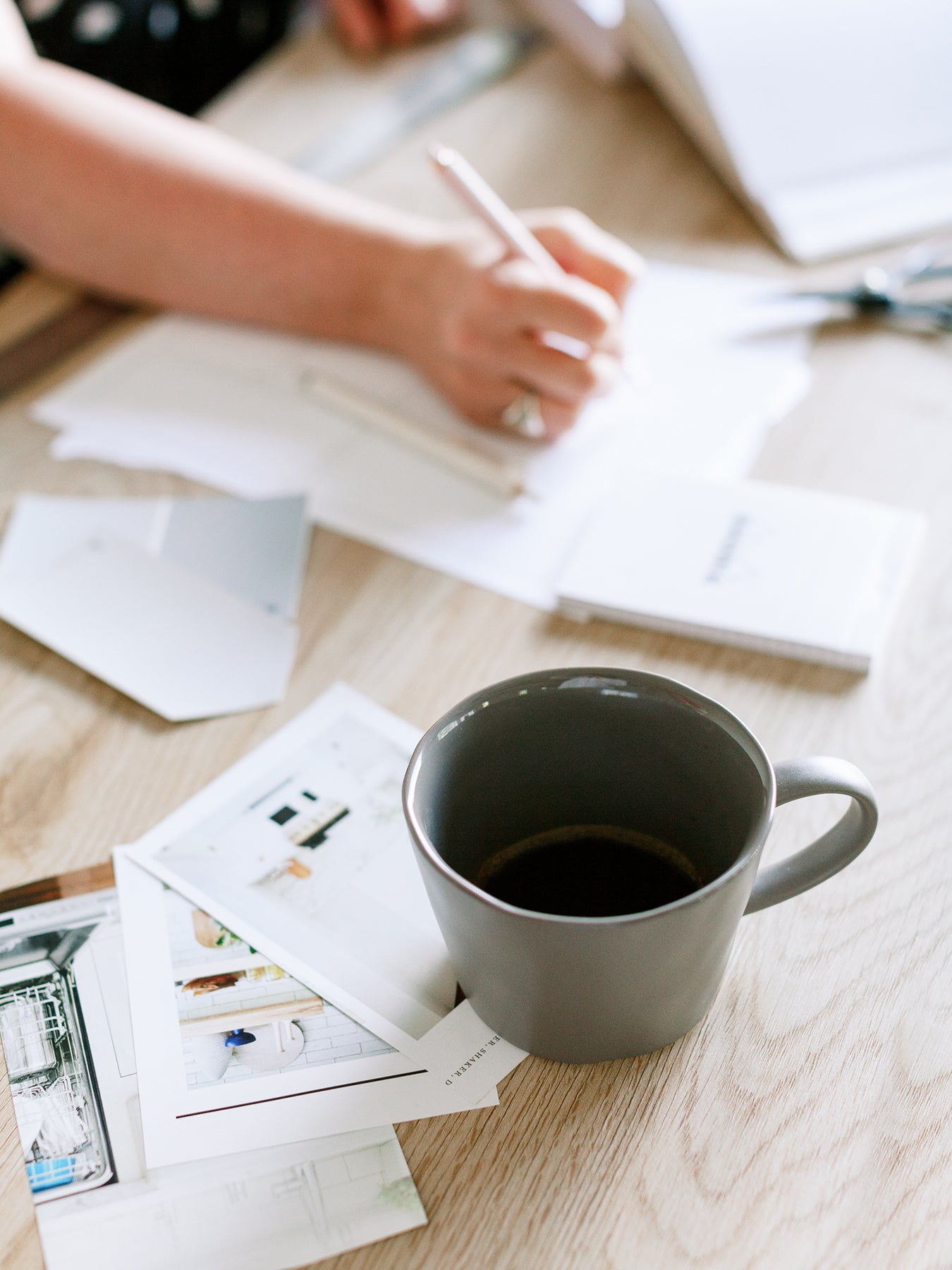 Workspace setup with coffee cup and papers illustrating Blu Paint Virtual Makeover Consultation