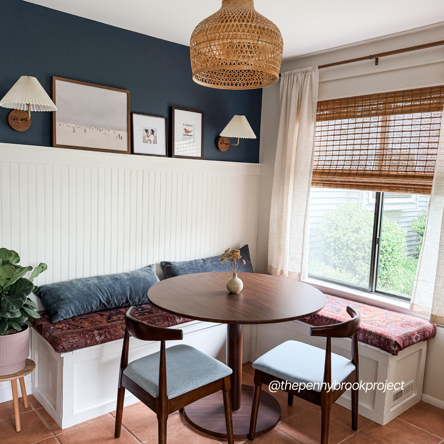 Cozy dining nook painted with After Hours interior paint dark blue by Blu Paint featuring wooden table and chairs