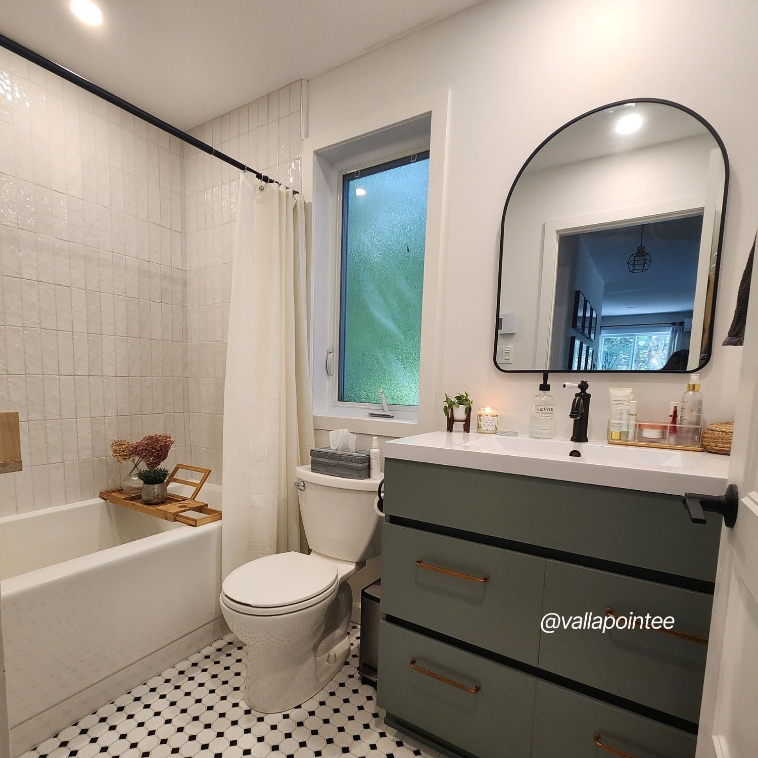 Modern bathroom with white walls bathtub patterned tile floor and green vanity showcasing soft neutral interior paint